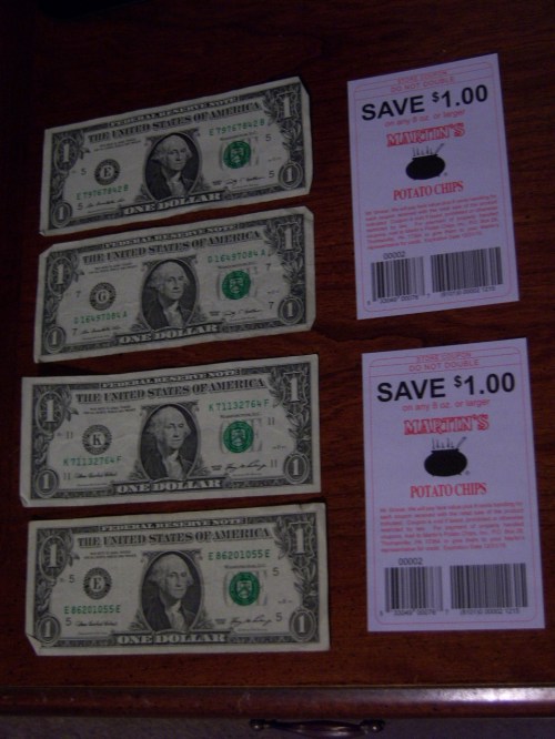 Four one dollar bills and two coupons